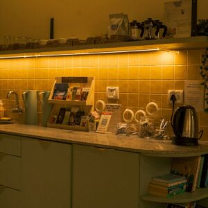 A kitchen counter with tea supplies and kettle.